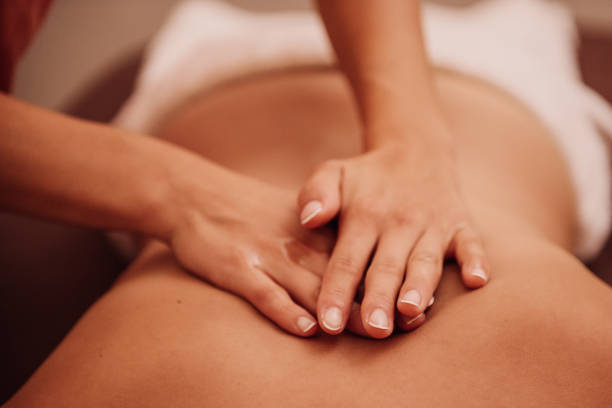 Woman Getting A Back Massage At A Spa Photo Taken Indoors With Stobe Light